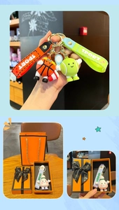Close-up of sports keychains in a gift box with basketball and tennis ball figures