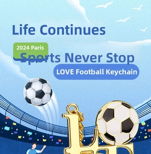 Detail view of a gold-finish LOVE metal keychain featuring a football as the letter O