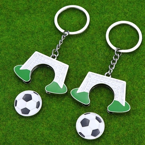 Football and goal post keychain set on green grass for soccer fans commemorative gift
