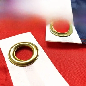 Close-up of durable brass grommets and reinforced stitching on a polyester world cup flag