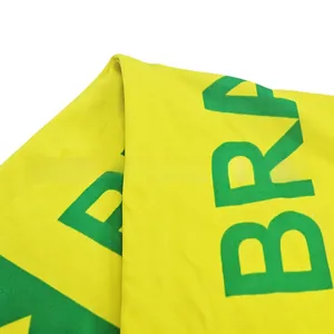 Close-up of yellow Brazil football scarf with green Brasil text and breathable texture