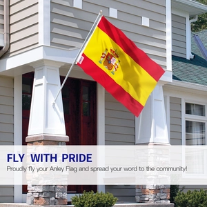 Outdoor view of a Spanish national flag with crest hanging at a house entrance