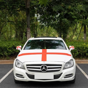 Detail of red cross hood decal and matching mirror covers on a white vehicle