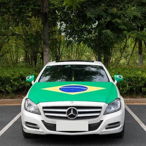 Detail view of Brazil flag car hood cover and side mirror socks on a white sedan