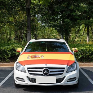 Car hood cover and mirror covers featuring the Spanish flag on a white luxury sedan