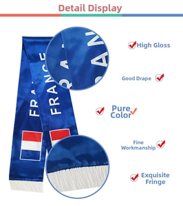 Detailed close-up of glossy France soccer fan scarf featuring white fringe and satin fabric