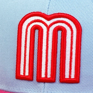 Macro view of 3D embroidered red letter m on light blue fabric of the baseball cap