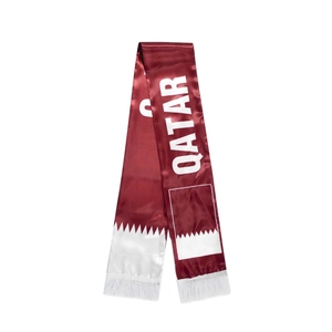 Detailed view of Qatar World Cup satin scarf featuring wine red colors and white fringes