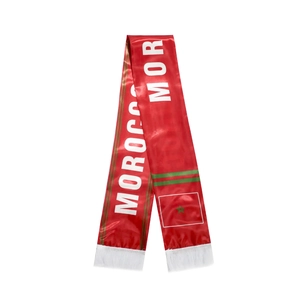 Detail view of red Morocco fan scarf with white MOROCCO text and national flag fringe