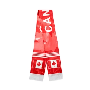 Detail of a silky Canada soccer fan scarf with maple leaf patterns and white tassels
