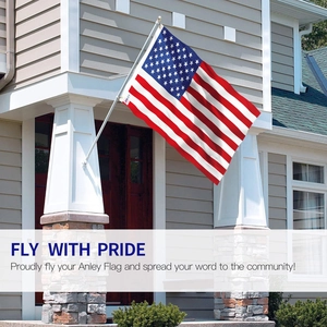 Polyester American flag on a silver metal flagpole mounted to a residential porch pillar