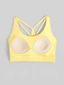 Pale yellow high-impact sports bra with cross-back straps and integrated pads
