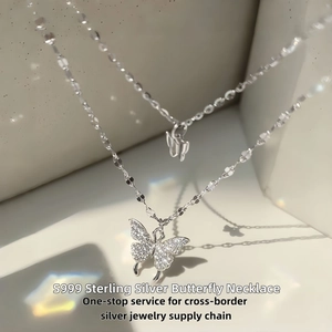 Macro shot of S999 sterling silver butterfly necklace with cubic zirconia and rainbow prism light