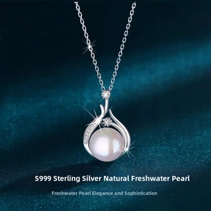 Macro detail of S999 silver teardrop pendant with natural freshwater pearl and zircons