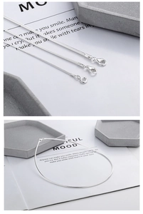 Detail view of S925 sterling silver snake bone necklaces showing clasp and thickness variety