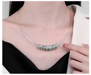 Close-up of S925 sterling silver tube pendant with intricate vintage flower relief carvings