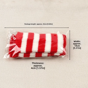 Detailed view of red and white striped knit leg warmers in 25x14x4cm packaging