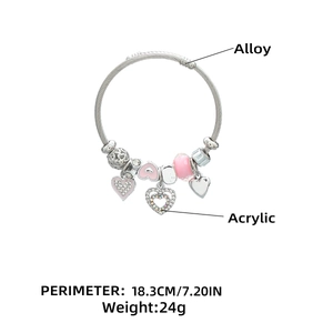 Detail of silver beaded heart charm bracelet with 18.3cm perimeter and pink accents