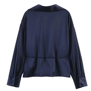 Rear view of dark blue satin shirt with waist belt detail and double-button cuffs