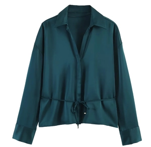 Detail of dark green satin shirt featuring a classic collar and waist drawstring tie