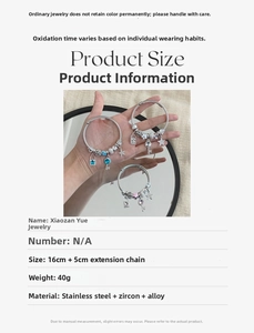 Detailed view of stainless steel charm bracelet set featuring star and key pendants