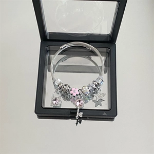 Silver stainless steel star and key charm bracelet in a luxury floating display box