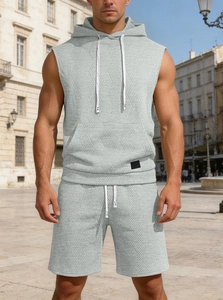 Detailed texture of men's sleeveless light grey hoodie and matching shorts set