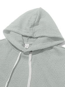Detail of grey sleeveless hoodie with chevron texture, white drawstrings and size L label