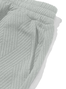 Detail of grey textured knit shorts with elastic waistband and herringbone pattern