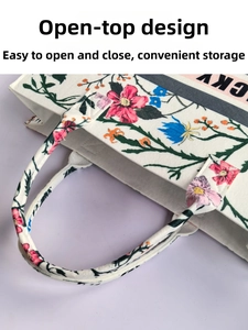 Detail of the open-top floral felt tote bag showing large capacity and lucky print