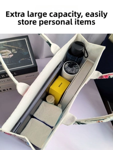 Top view of spacious floral tote bag interior showing laptop and daily essentials