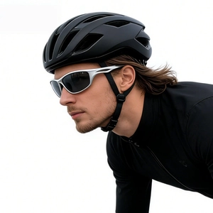 Close-up of matte black cycling helmet and silver frame sport sunglasses with UV protection