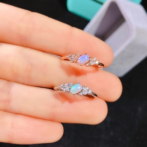 Elegant oval natural opal ring with side diamonds in rose gold and silver finishes