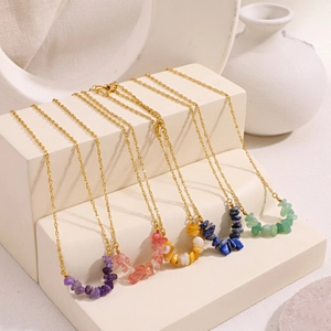Detail of natural stone chip pendants on gold stainless steel link chains