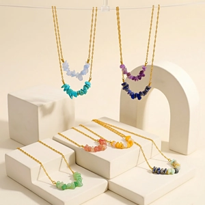 Detail of natural irregular stone necklaces in various colors on golden chains