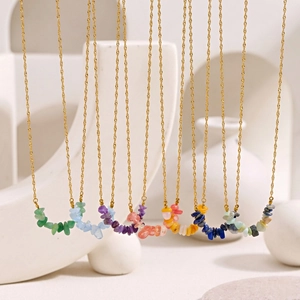 Detail of colorful irregular gemstone chips on elegant golden stainless steel chains