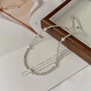 Elegant S925 silver crushed bead necklace with pearls on a wooden tray setting