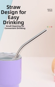 Close-up of purple stainless steel tumbler with transparent lid and reusable metal straw