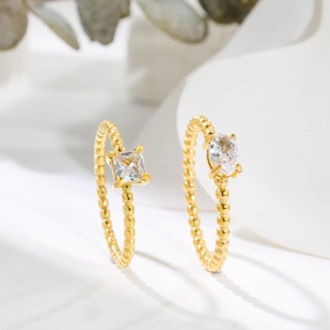 18K gold plated beaded rings set with oval and square zircon stones on white display