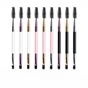 Detailed view of dual-ended eyebrow brushes with spiral spoolie and angled brush heads