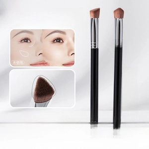 Macro detail of triangular concealer brush with synthetic bristles for smooth highlighting