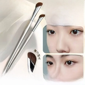 Detailed view of horse hair nose shadow brush with ergonomic sickle-shaped head