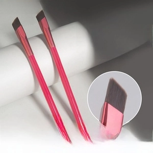 Detail showing two professional square eyebrow brushes with pink handles and angled bristles