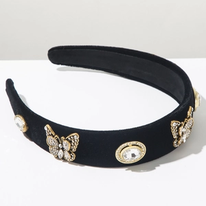 Detail of black velvet headband with golden crystal butterflies and rhinestone gems