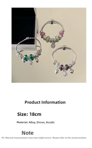 Detailed view of beaded snake bone bracelets with heart charms and zircon stones