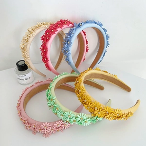 Detail of colorful floral headbands with rhinestone accents and anti-slip lining