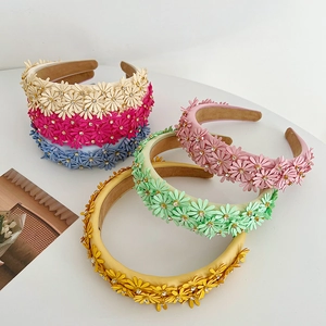 Detail of colorful floral headbands with 3D daisy flowers and sparkling rhinestones