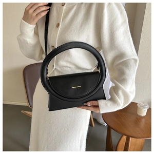 Detailansicht der schwarzen Lederhandtasche mit Rundgriff und goldener Fashion & Bags Aufschrift