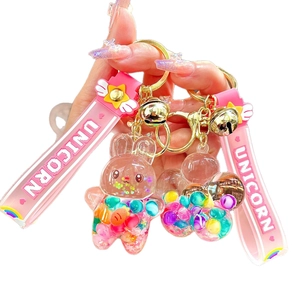 Pink unicorn liquid sand keychain with colorful beads and silicone strap in hand