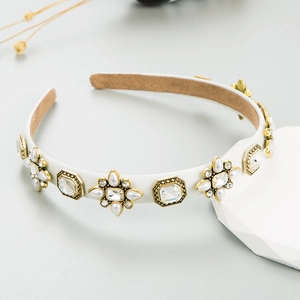 Detail of vintage headband with rhinestones and pearls on white fabric band